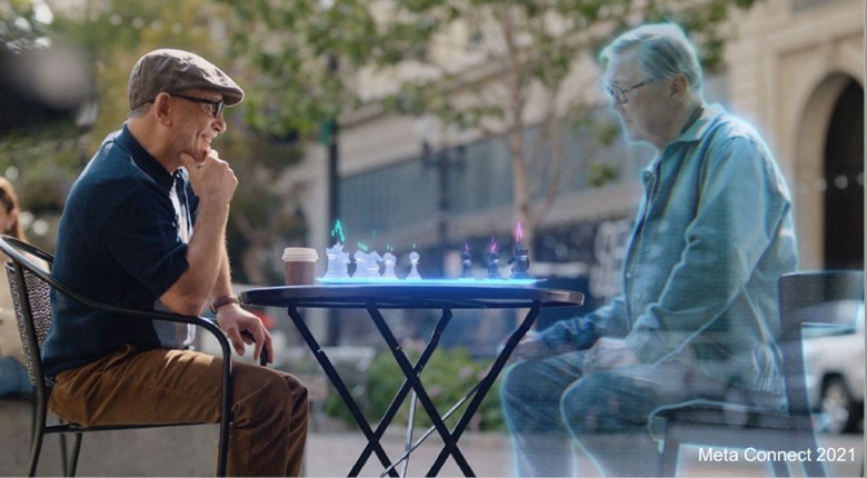 Picture of a man playing chess on a virtual chess board with a remote, computer-generated friend (Courtesy, Meta, Inc.)